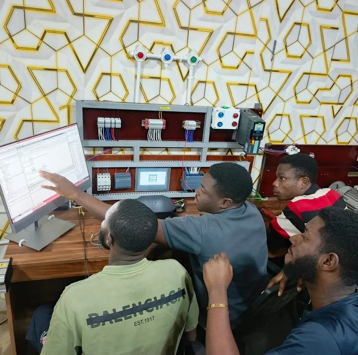 Trainees programming a PLC and touch-screen HMI training panel